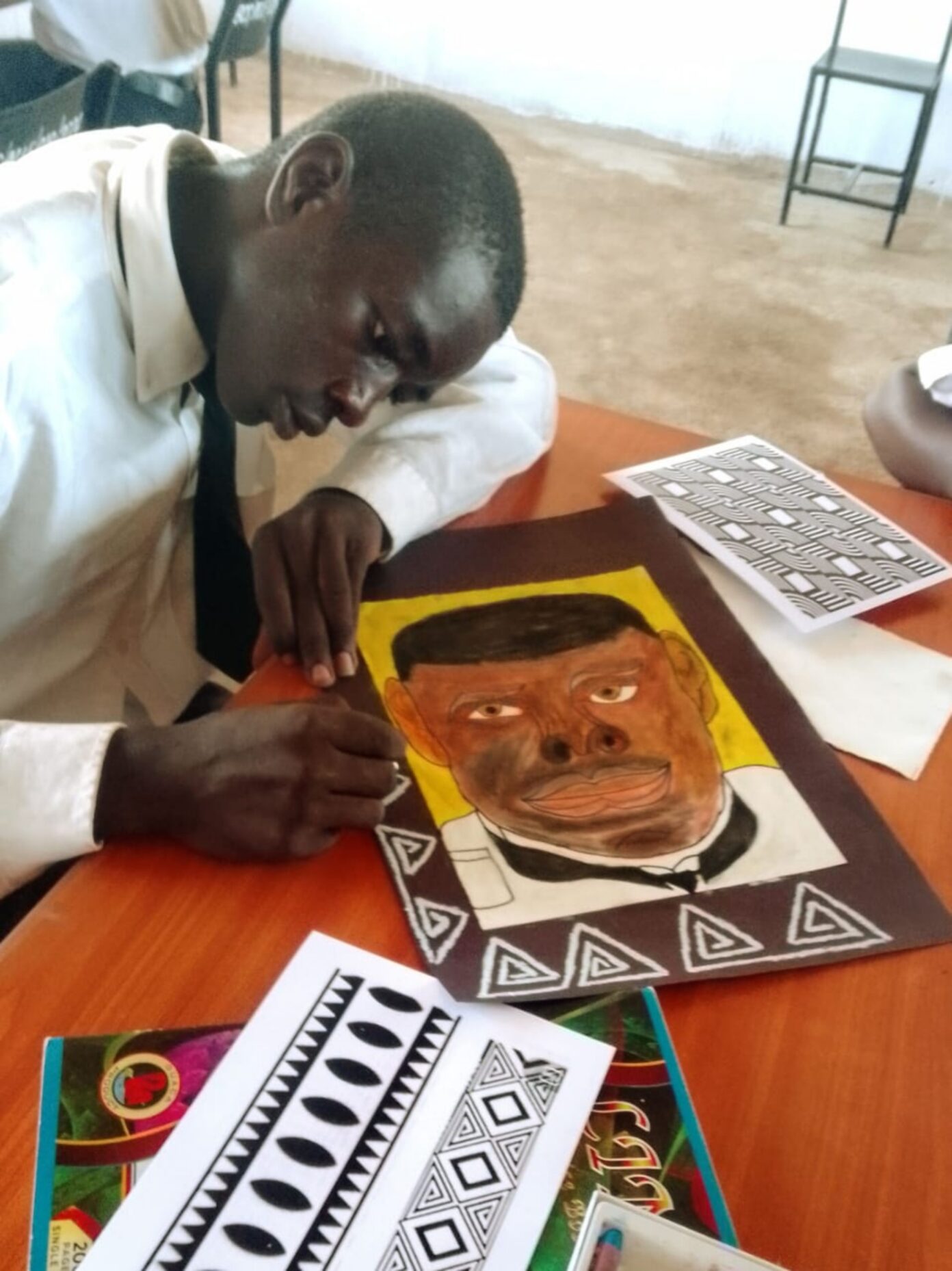 Alex Otieno working on his portrait
